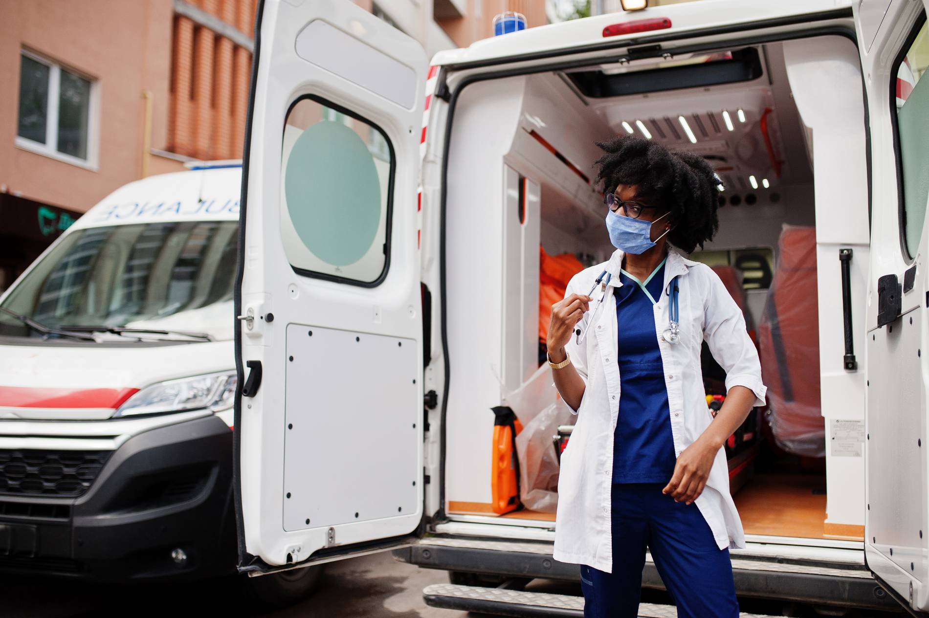 Ambulancière devant une ambulance médicalisée